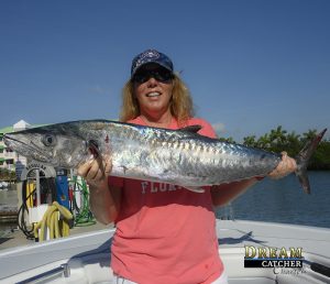 Fishing Key West reef for kingfish. This lady angler holds up a nice kingfish. 