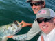 two guys holding up a tarpon in Key West